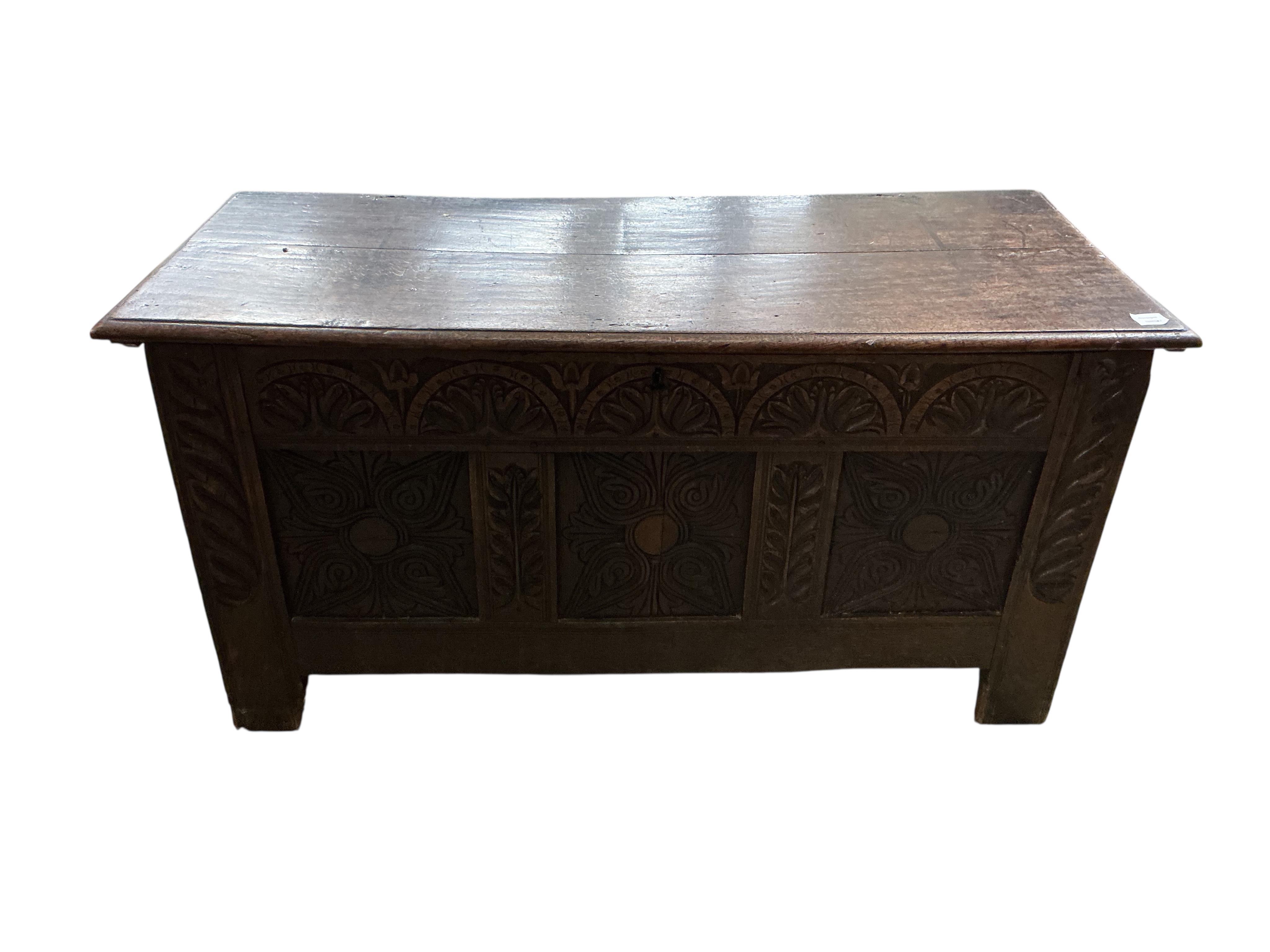 An 18th century carved oak coffer, width 132cm, depth 56cm, height 64cm